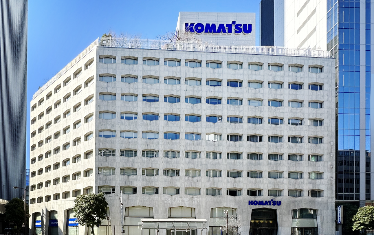 大理石の外壁に横に長い六角形の窓が特徴的な旧本社。