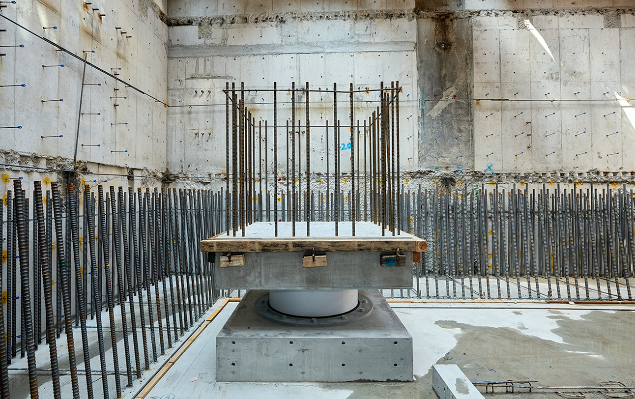 Underground base isolation devices reduce earthquake vibrations transmitted to the building.